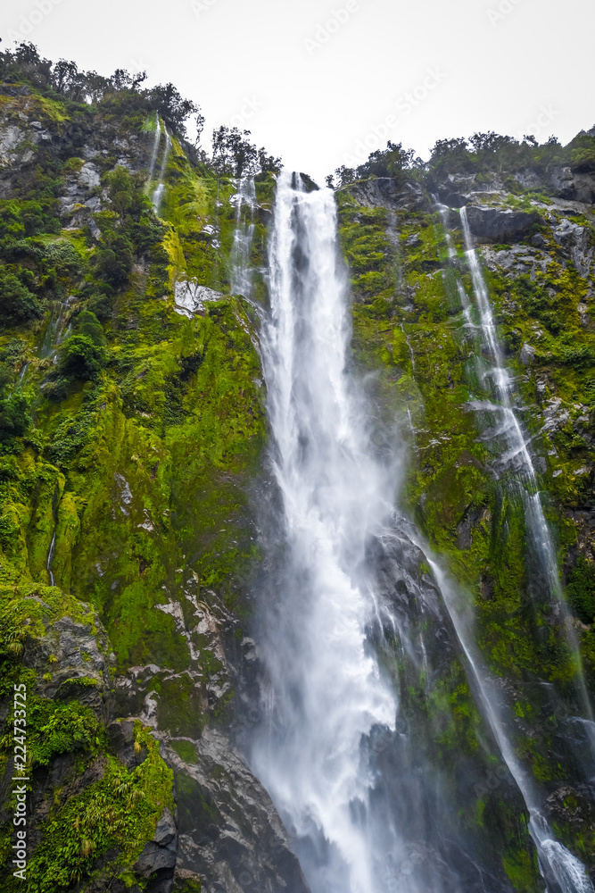 Waterfall in Milford Sound lake, New Zealand