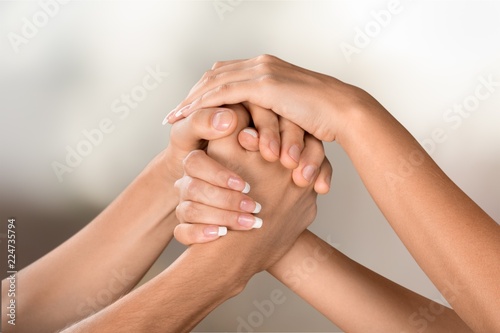 Hands of man and woman holding together