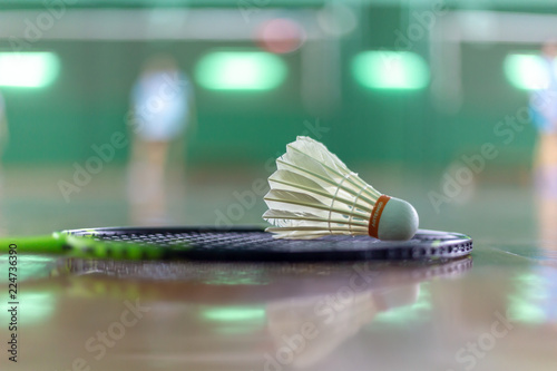 Shuttercock on badminton racket with blurred background
