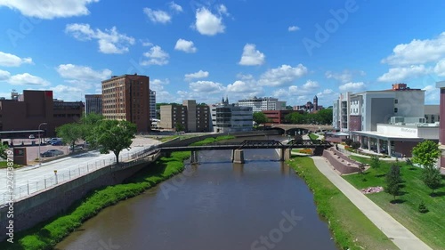 Downtown Sioux Falls, SD over the Big Sioux River with people riding bikes on the bike trail
