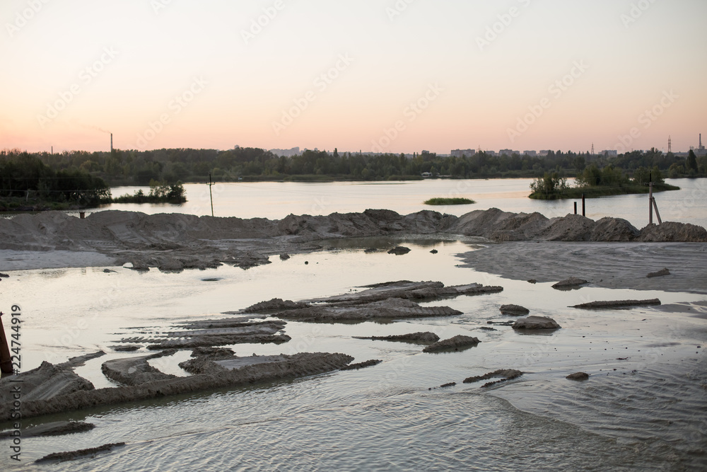 sand pit. river at sunset. Islands of sand. pine forest by the river. sand cliff