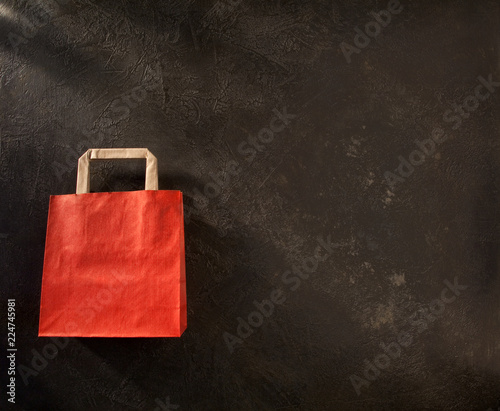 Red paper shopping bag on black background