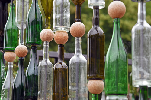 Detail of structure made of empty wine bottles and cork balls photo