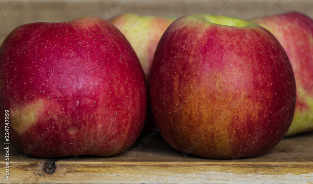 Closeup of ripe juicy big red apples on a wooden table. healthy eating. vitamins on the table Closeup of ripe juicy big red apples on a wooden table. healthy eating. vitamins on the table