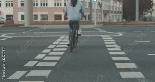 Wallpaper Mural Young woman walking on city streets with bicycle . Gir bike rider crossing pedestrian crossing . 4K video shooting by handheld gimbal Torontodigital.ca