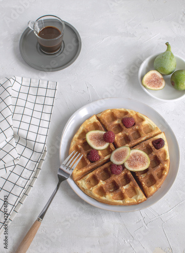 Belgian waffles Slow food breakfast concept figs raspberries Espresso coffee white wooden background Flat lay Copy space Toned image