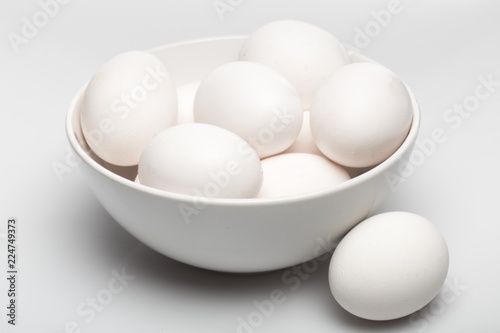 White Eggs in a Bowl on Grey Background