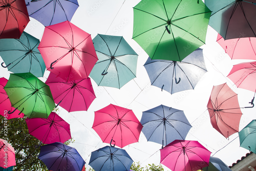 Beautiful display of colorful hanging umbrellas in a outdoor, Colorful hanging umbrellas on white sky background in Sunny day Beautiful display of colorful hanging umbrellas in a outdoor, Colorful hanging umbrellas on white sky background in Sunny day