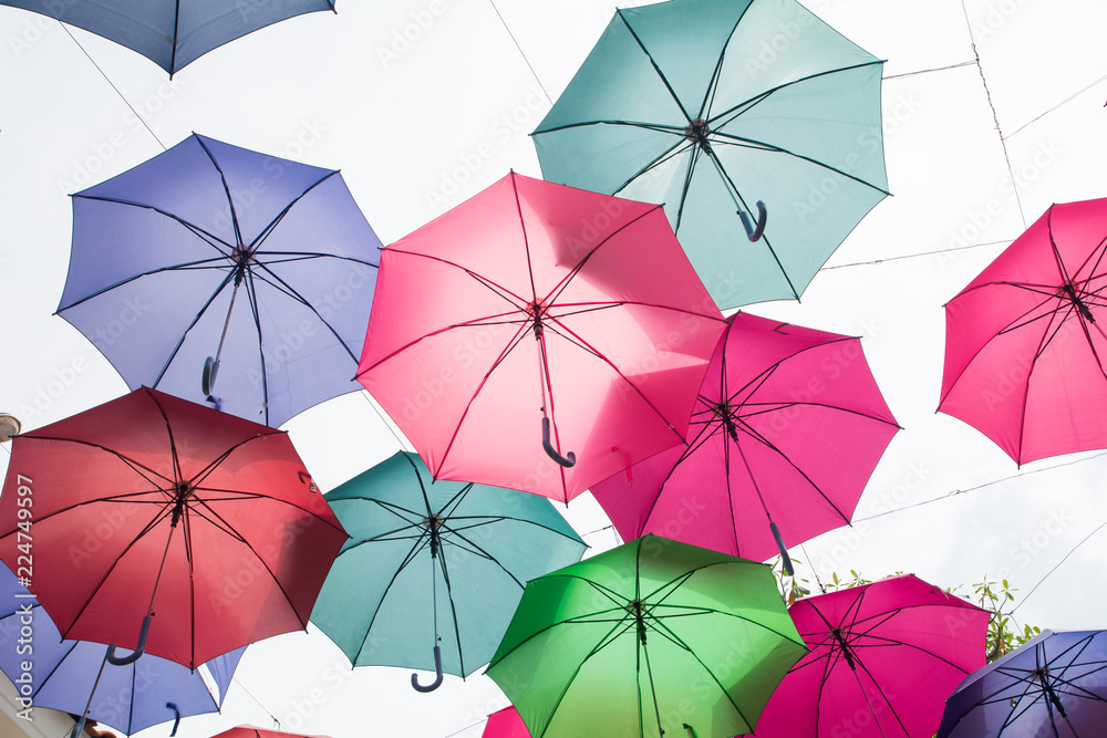 Beautiful display of colorful hanging umbrellas in a outdoor, Colorful hanging umbrellas on white sky background in Sunny day