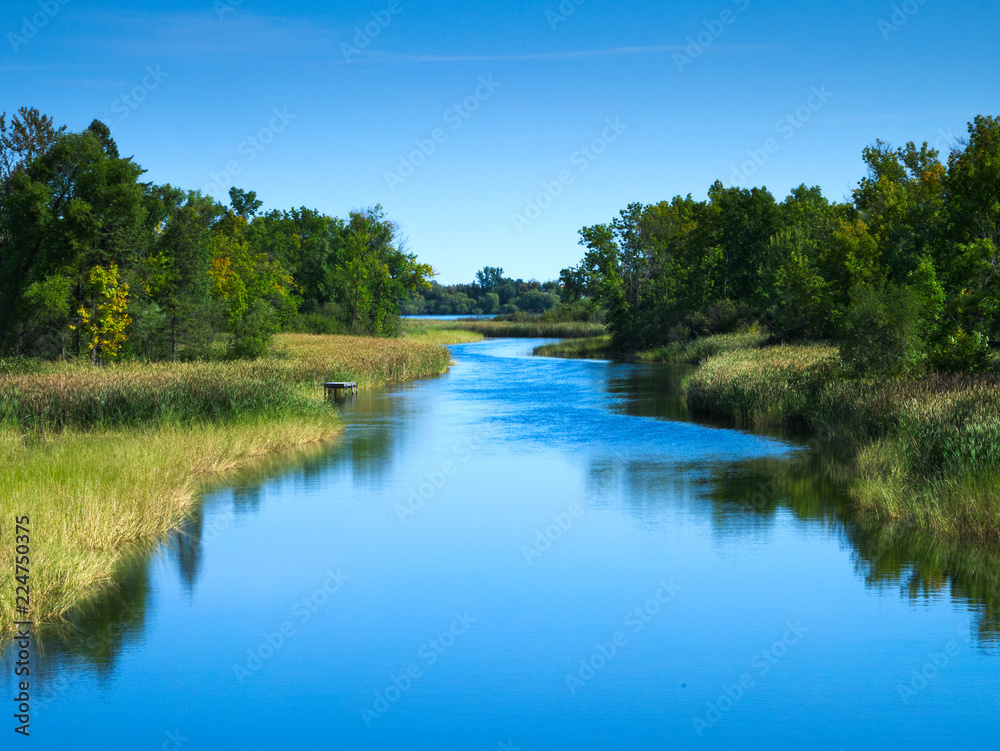 Mississippi River flows north toward Bemidji Minnesota near hiway 2. This scene is a few miles from the source at Lake Itasca