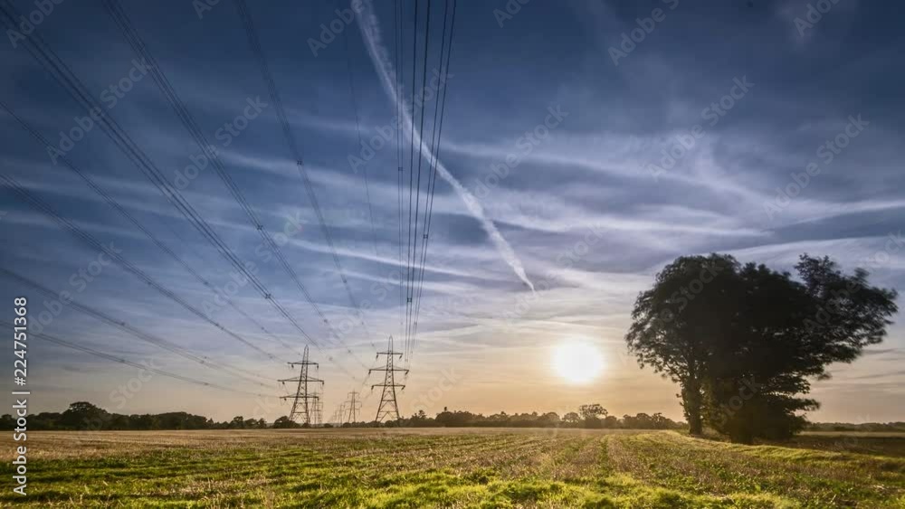 High voltage electricity pylons sunset time lapse