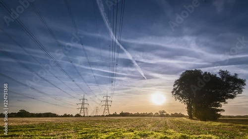High voltage electricity pylons sunset time lapse