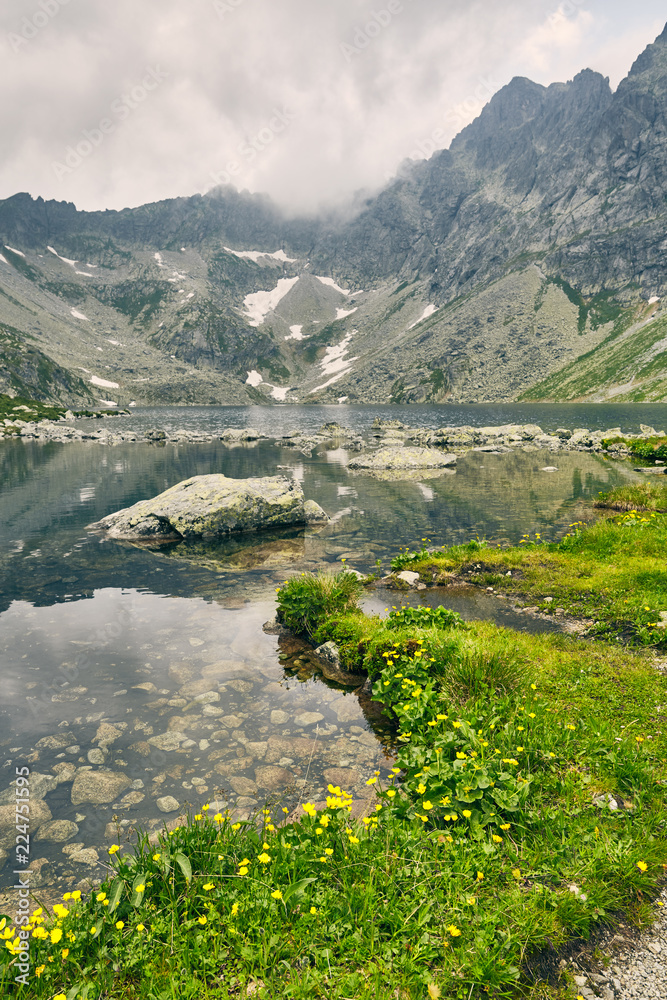 Hincovo pleso. Pure lake with a rocky bottom on the background of the mountains of the High Tatras