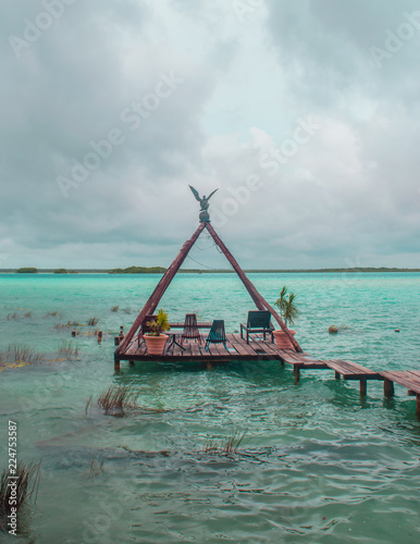 Wood dock in Bacalar's lake and blue sky