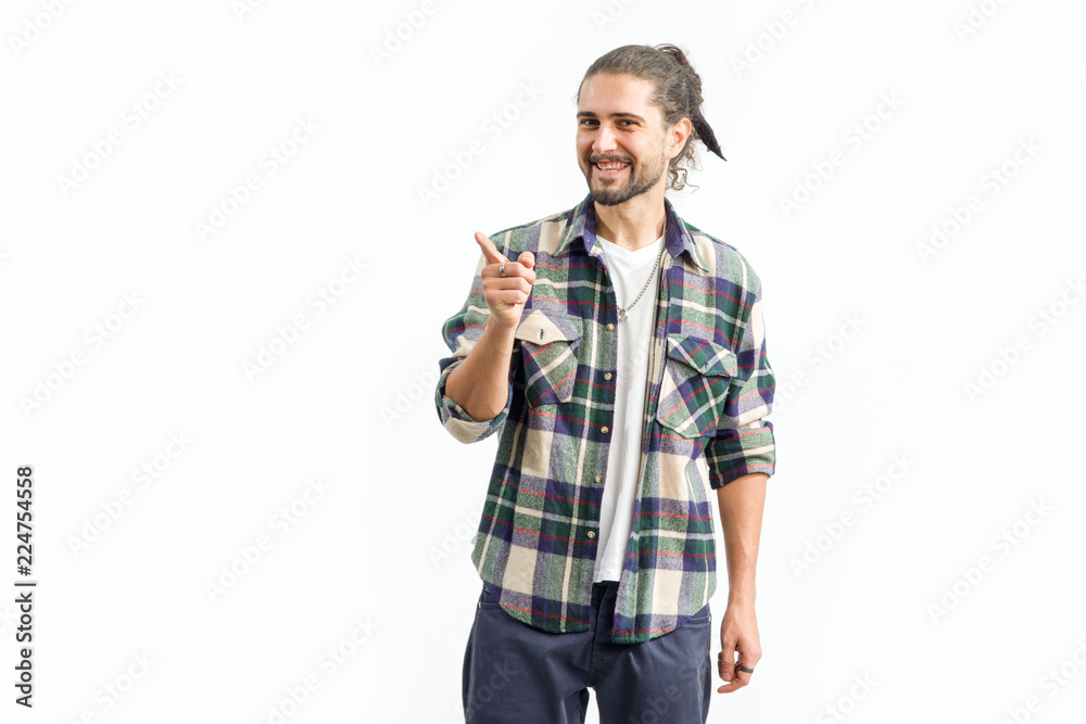 Cheerful man with a beard is pointing his finger to the side. Cheerful man with a beard is pointing his finger to the side.