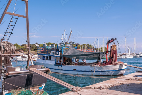 an old fishing boat is prepared to go out to sea for fishing. the quota for catching fish. small business