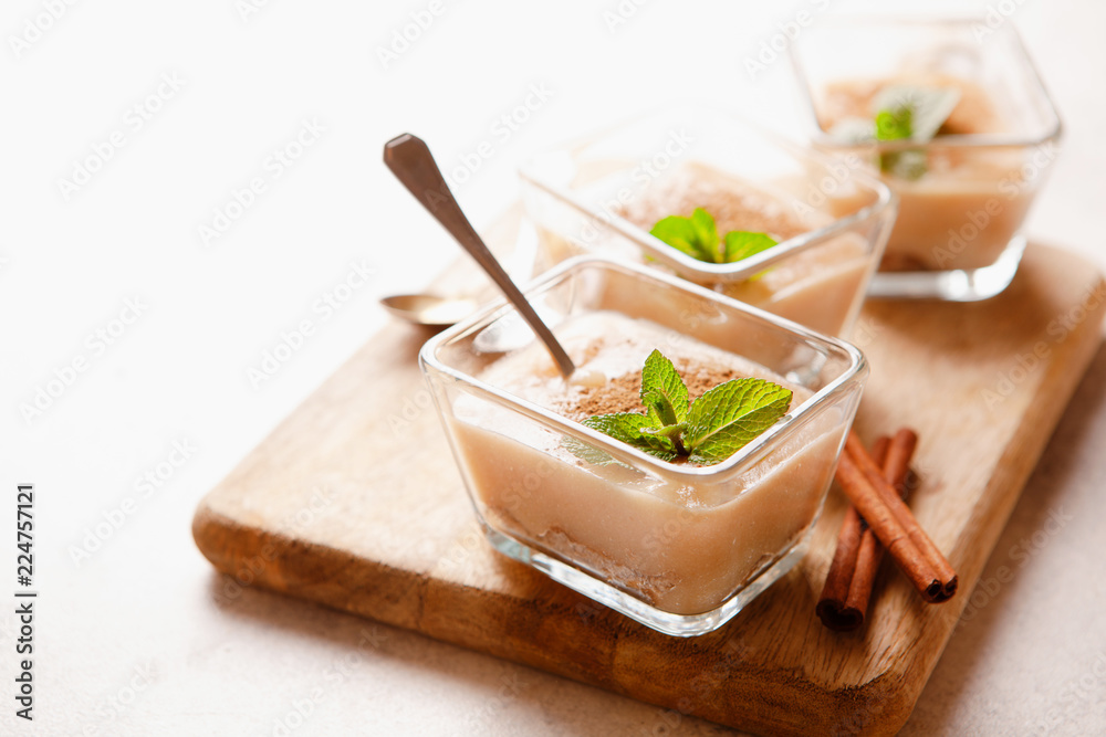 Cashew vegan cake with apple mousse and cinnamon in portion bowls decorated with mint overhead Cashew vegan cake with apple mousse and cinnamon in portion bowls decorated with mint overhead