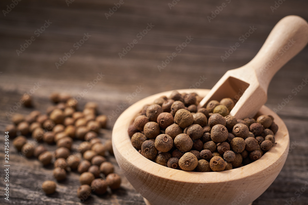 Allspice on rustic background,selective focus.