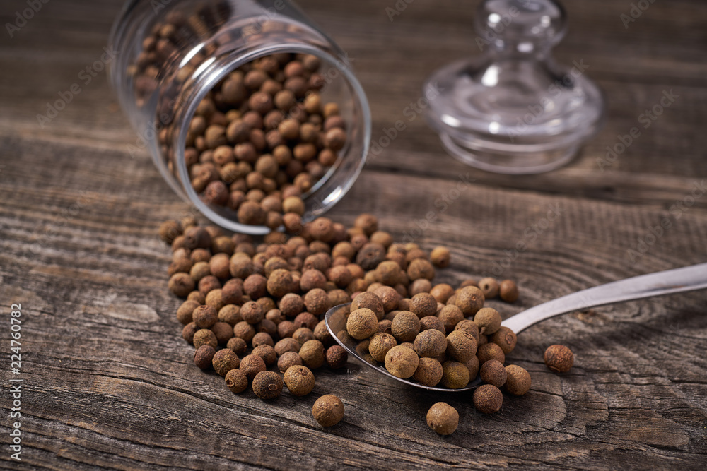 Allspice pepper in a metal spoon selective focus Allspice pepper in a metal spoon selective focus