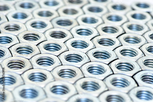 Fasteners on a white background. Manufacture of metal products.