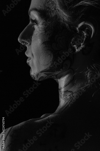 Black and white closeups of a fit woman with tattoos