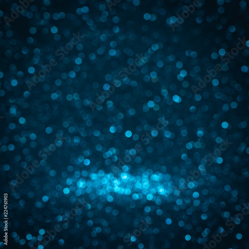 dark Blue background for christmas navy glitter sparkle. Abstract bokeh light shiny dark holiday. © arwiyada