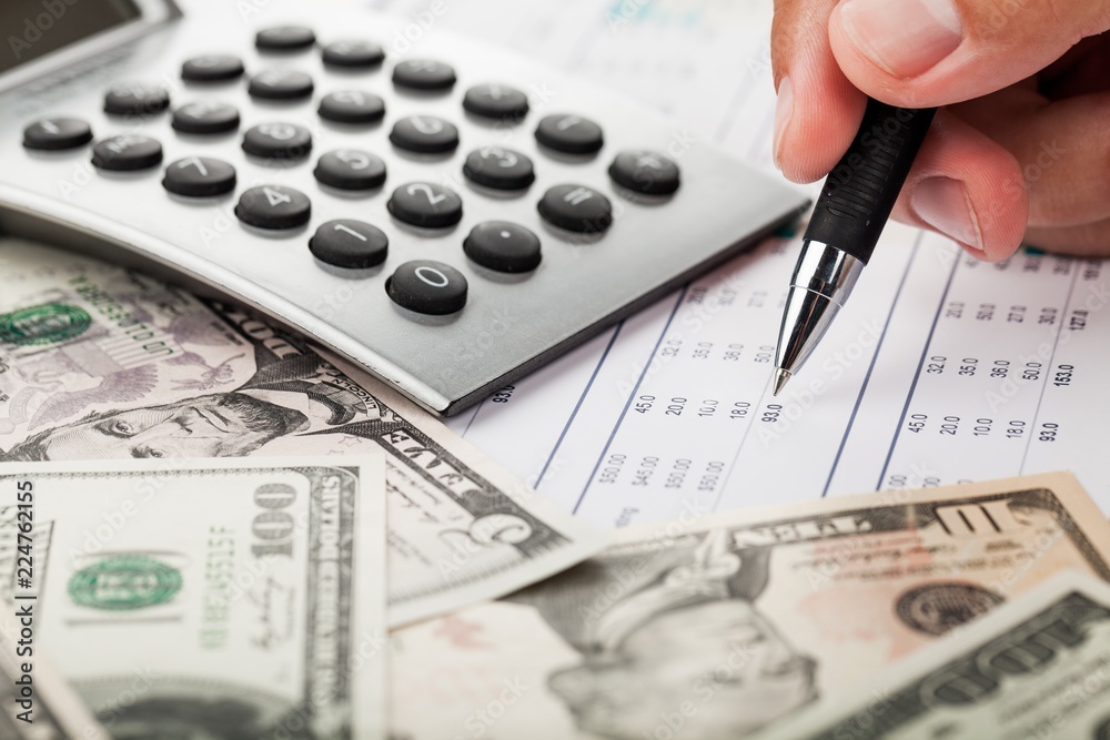 Fototapeta premium Close-up of a Businessman Analyzing Financial Figures with