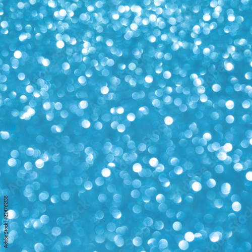 Blue background for christmas silver glitter sparkle. Abstract bokeh light shiny dark holiday.