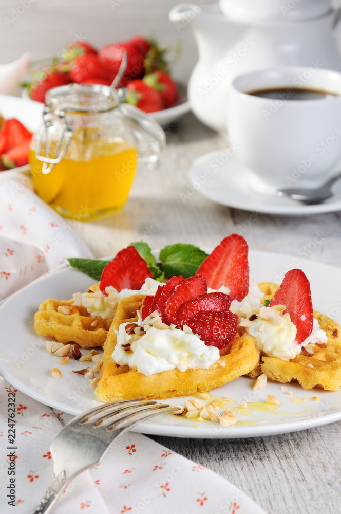 Belgian waffles with whipped cream and strawberries Belgian waffles with whipped cream and strawberries