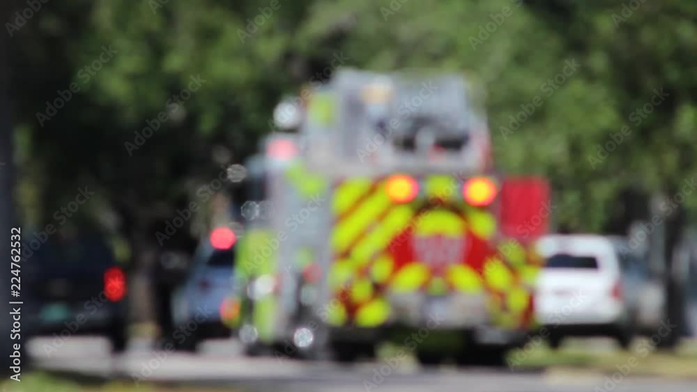 Fire truck and Polce S.U.V. at accident scene with lights on/intentionally blurred with heat distortion