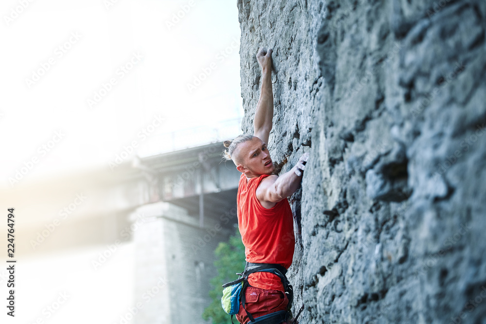 rock climbing. man rock climber climbing the challenging route on the rocky wall rock climbing. man rock climber climbing the challenging route on the rocky wall