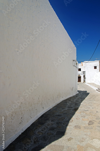 Fototapeta Naklejka Na Ścianę i Meble -  A view of streets and ancient houses in the island of Patmos, Greece in summer time