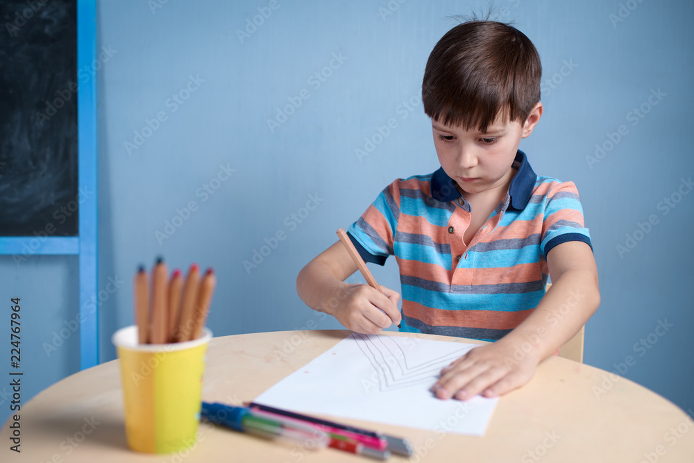 Caucasian boy carefully drawing with colorful pencils. Caucasian boy carefully drawing with colorful pencils.
