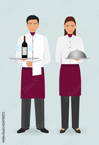 Restaurant team concept. Couple of waiter and waitress with dishes and in uniform stand together.