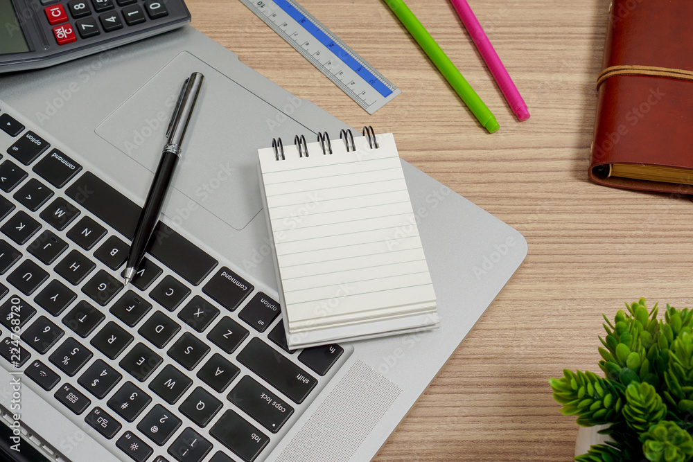 Notebook and laptop on wood working desk. Text copy space. Notebook and laptop on wood working desk. Text copy space.
