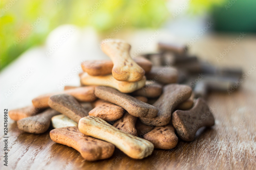 Fototapeta premium Dog tasty colored biscuits on wooden background 