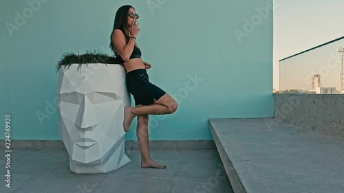 young sexy woman enjoying a cigarette in a nice clean design minimal environment