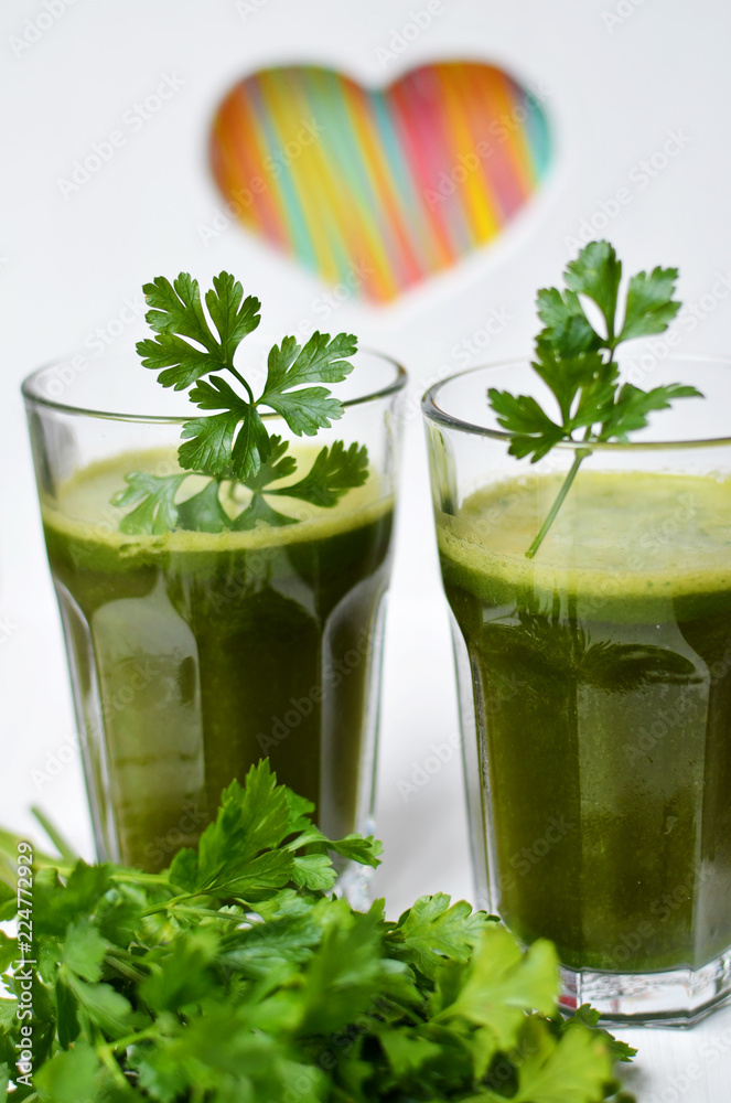 Detox green cocktail with parsley in glass with colourful heart Detox green cocktail with parsley in glass with colourful heart