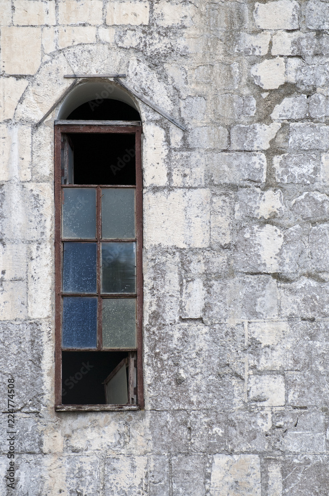 Old beautiful Windows in a large stone house.