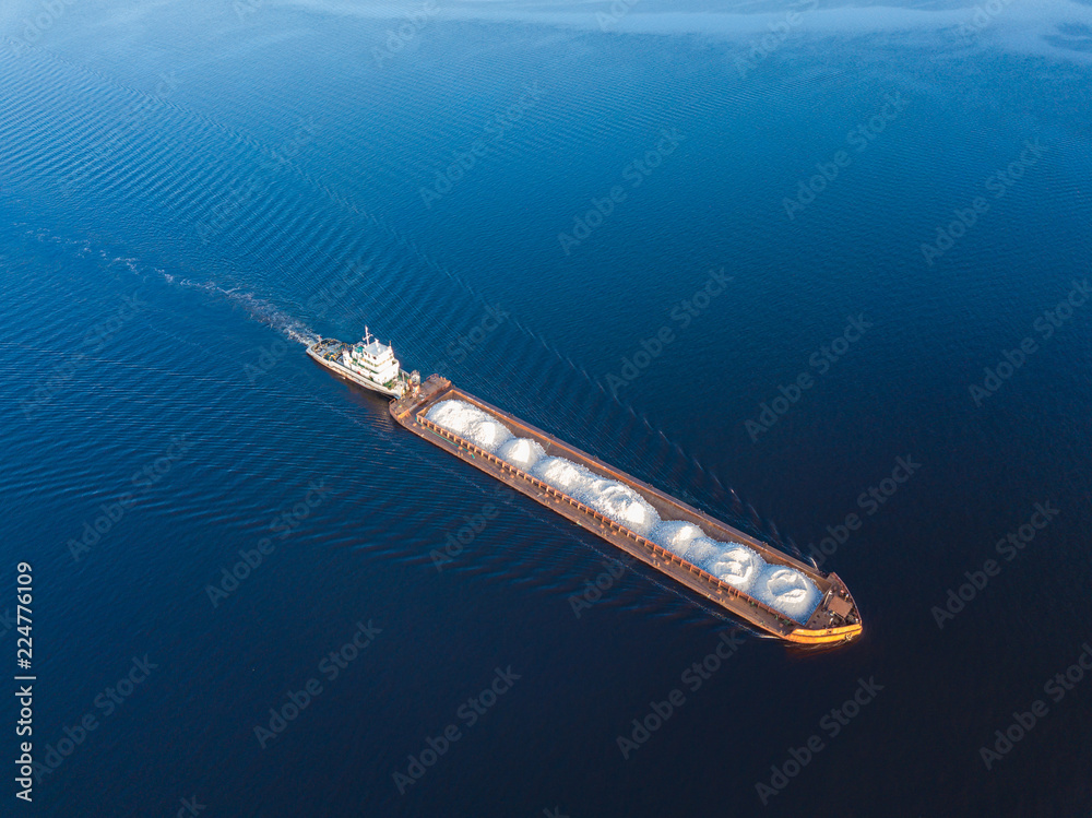 Aerial view carrier ship on river Volga. Cargo ship photo from drone. Aerial view carrier ship on river Volga. Cargo ship photo from drone.