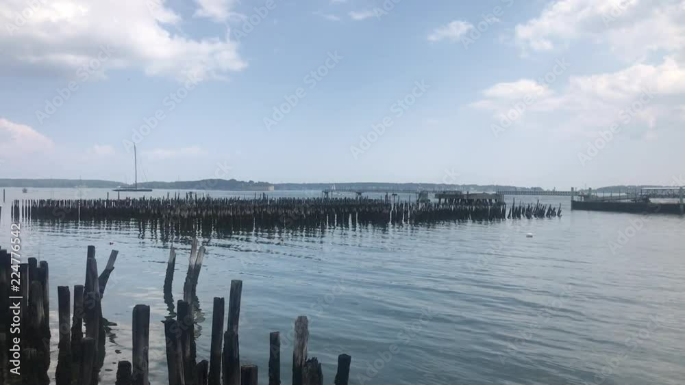 Beautiful View of Old Pier Posts Pilings under a Blue Sky Ocean Gateway Pier Beautiful View of Old Pier Posts Pilings under a Blue Sky Ocean Gateway Pier