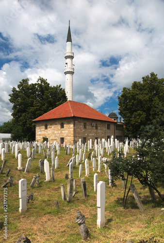 Ahmed-begova džamija (mosque) surrounded by a cemetery. The mosque is located in Vitez, Bosnia and Herzegovina. photo