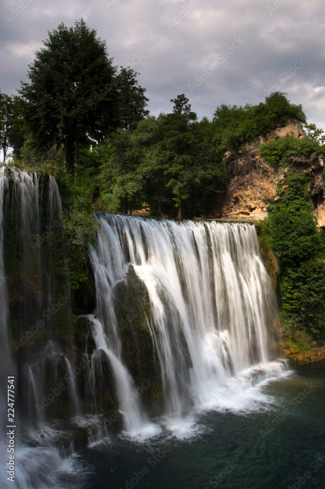 Naklejka premium A detailed view at Pliva waterfall (Plivski vodopad) located in the city center of Jajce, Bosnia and Herzegovina.