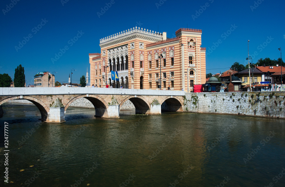 Sarajevo City Hall, known as Vijećnica, is located in the city center of Sarajevo on the bank of Miljacka river.