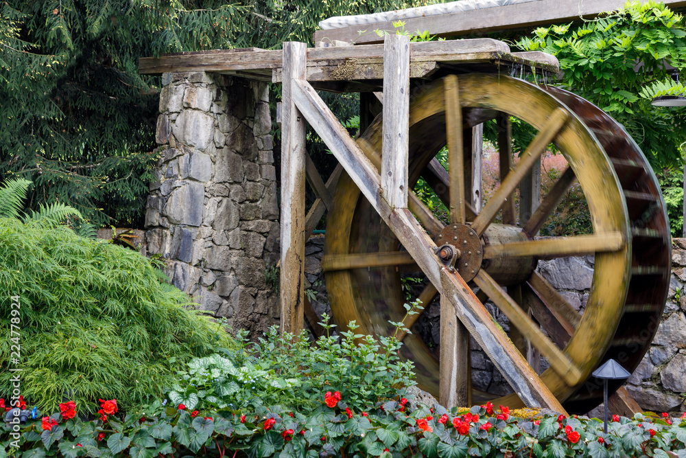 Water mill in Butchart gardens, Victoria, British Columbia, Canada..