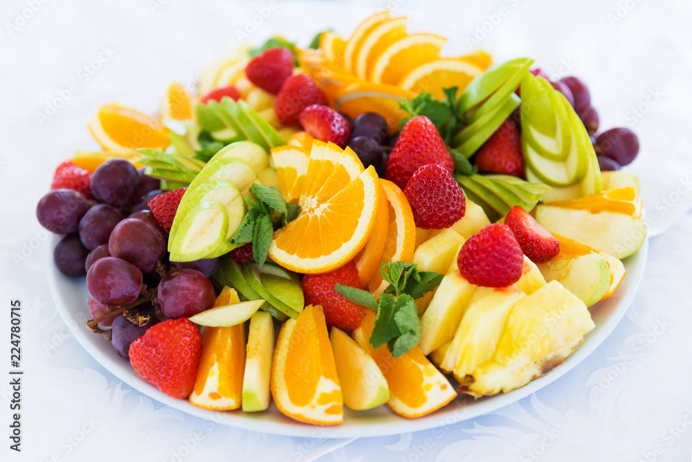 Party plate with fresh fruit cuts on table Party plate with fresh fruit cuts on table