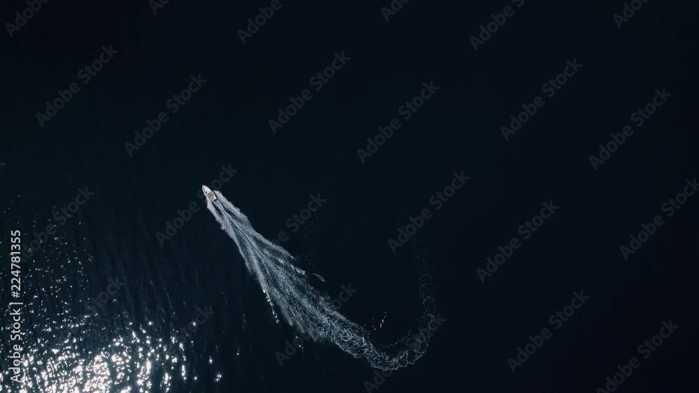 Aerial - Top down view of motorboat doing a heart shape pattern