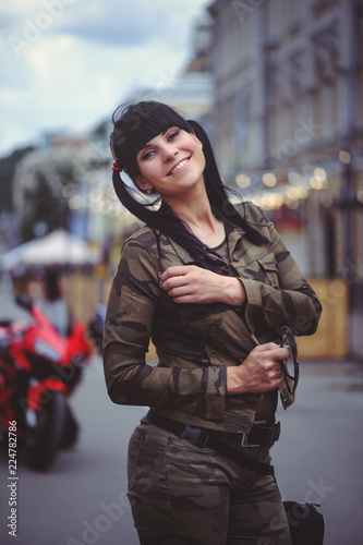 happy brunette woman outdoors in the city © lanarusfoto