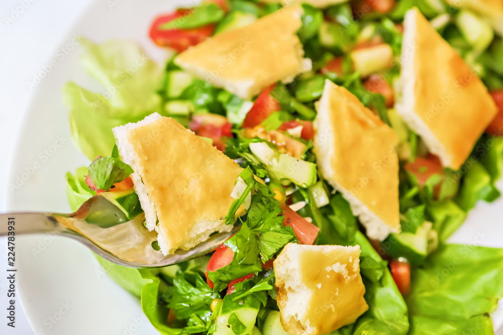 Bite of Lebanese Fattoush or Bread Salad on a fork Bite of Lebanese Fattoush or Bread Salad on a fork