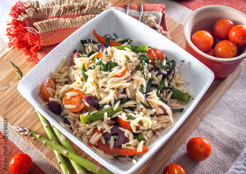 Orzo pasta salad with salted vegetables photo